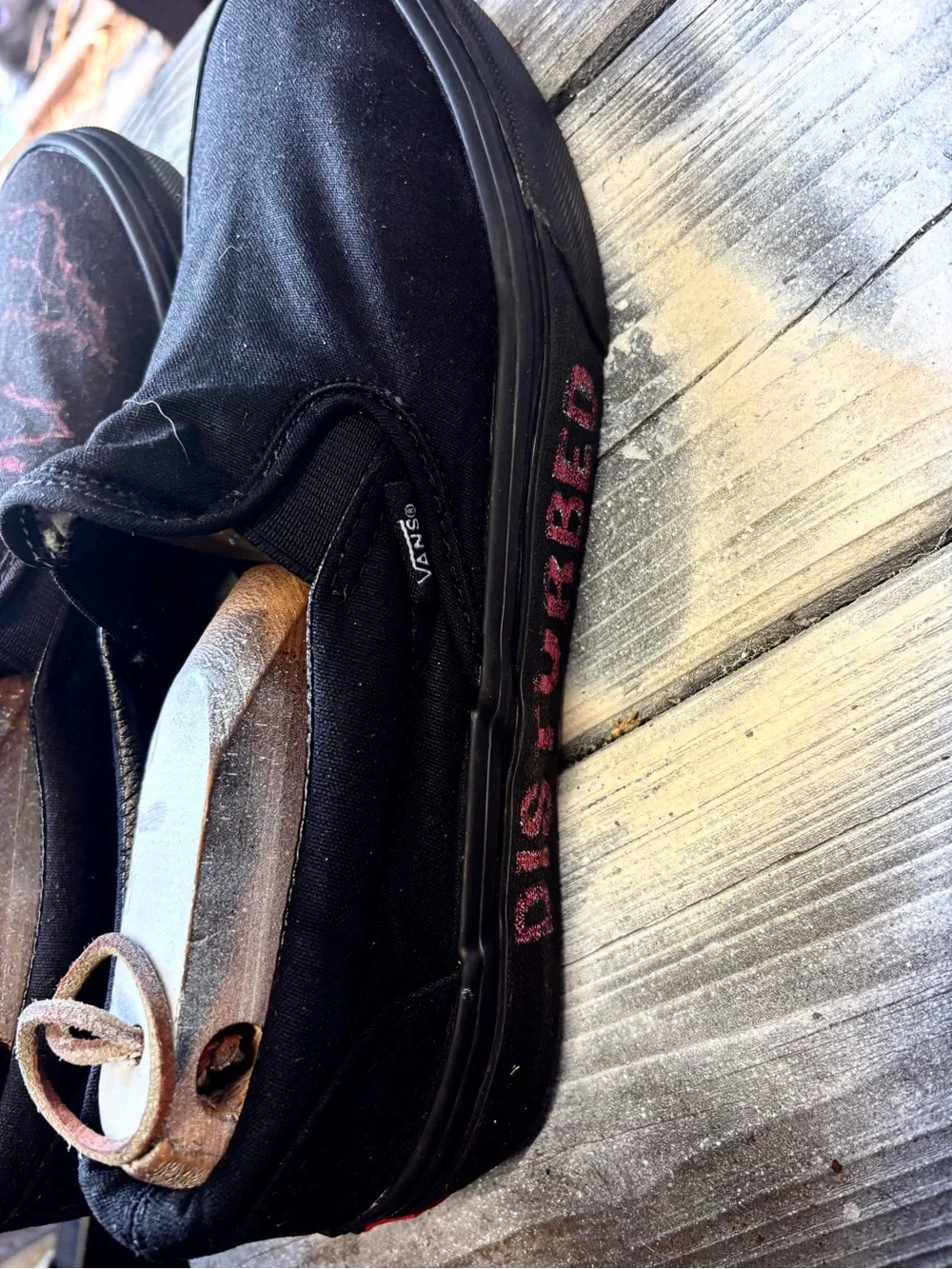 Vans black slip-on canvas sneakers with red hand-painted smiley face